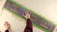 Use repositionable spray adhesive and frog tape to hold the stencil in place