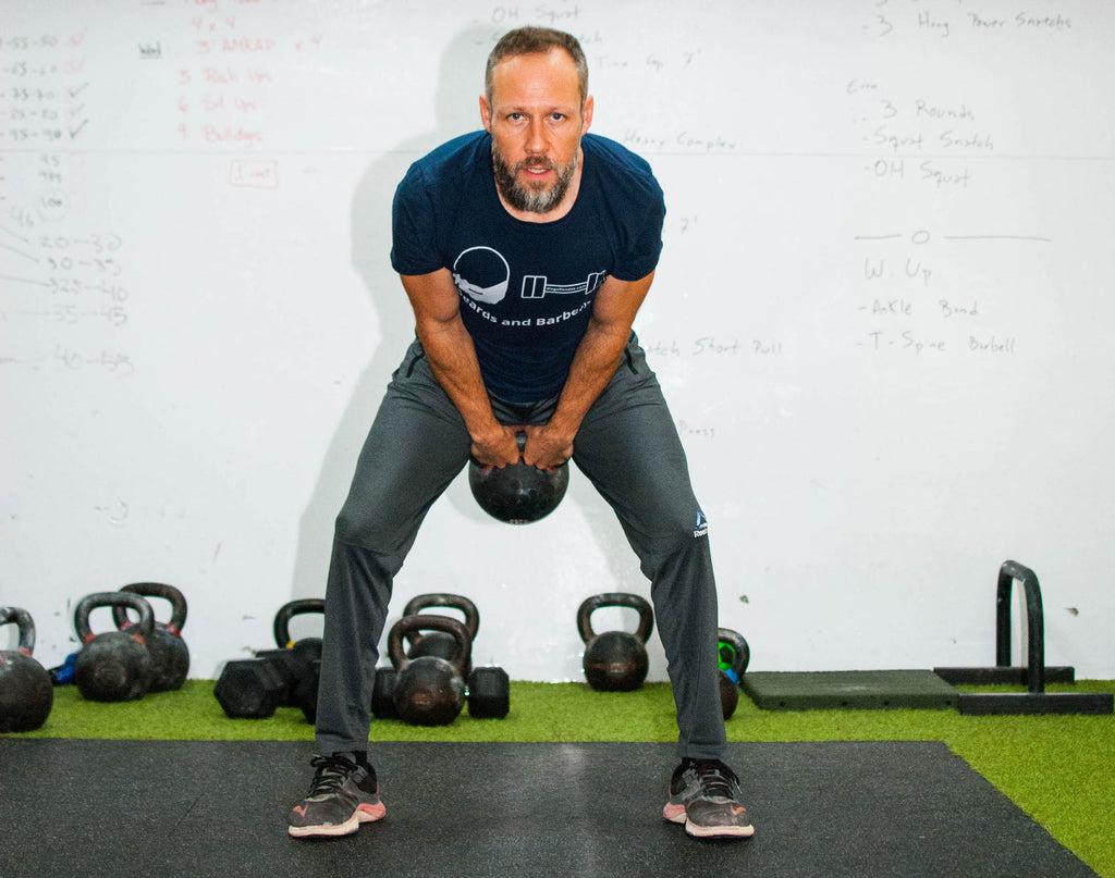 Men doing kettlebell swings