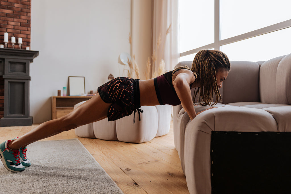 Woman does pushup on couch