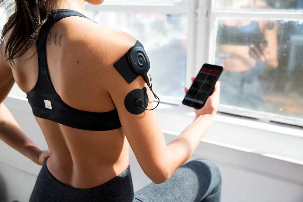 woman checking her phone while exercising