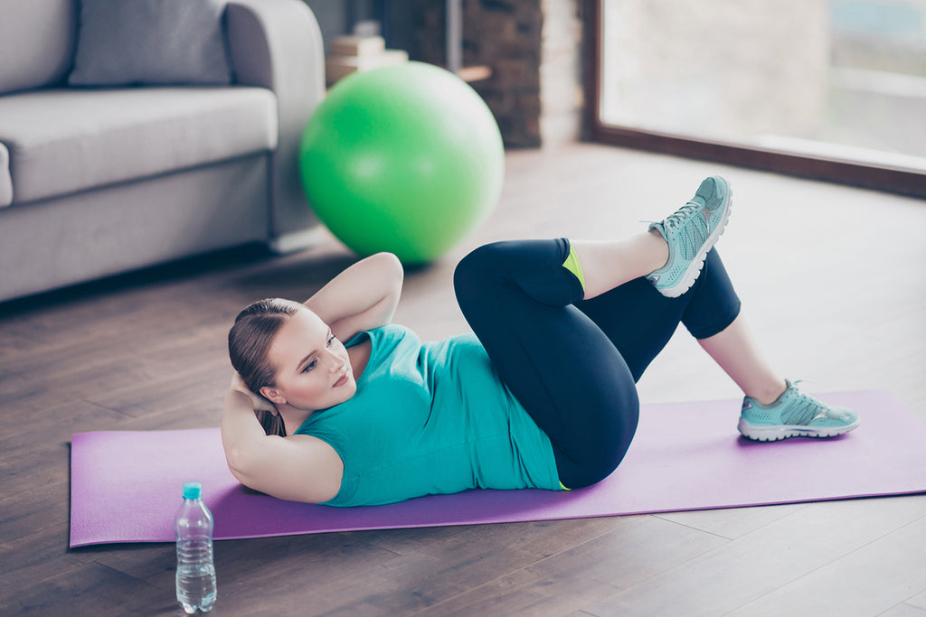 Hypertrophy vs Strength: Woman exercising using mat on the floor