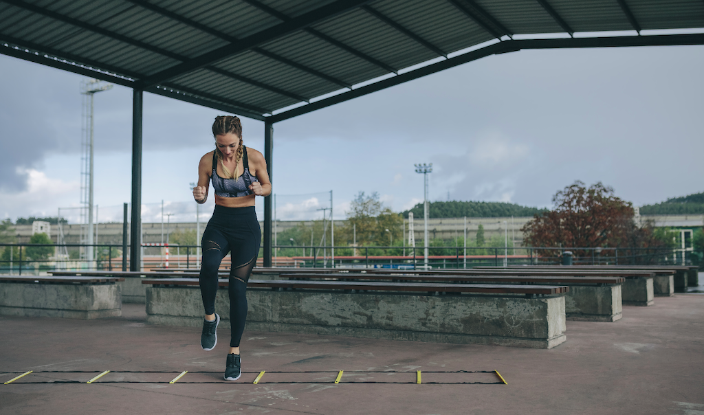 health related fitness: woman doing ladder drills