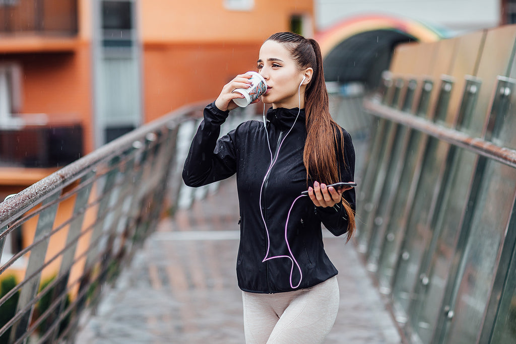 woman drinking coffee while walking