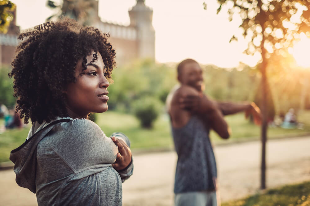 mind body and soul: two people stretching outdoors