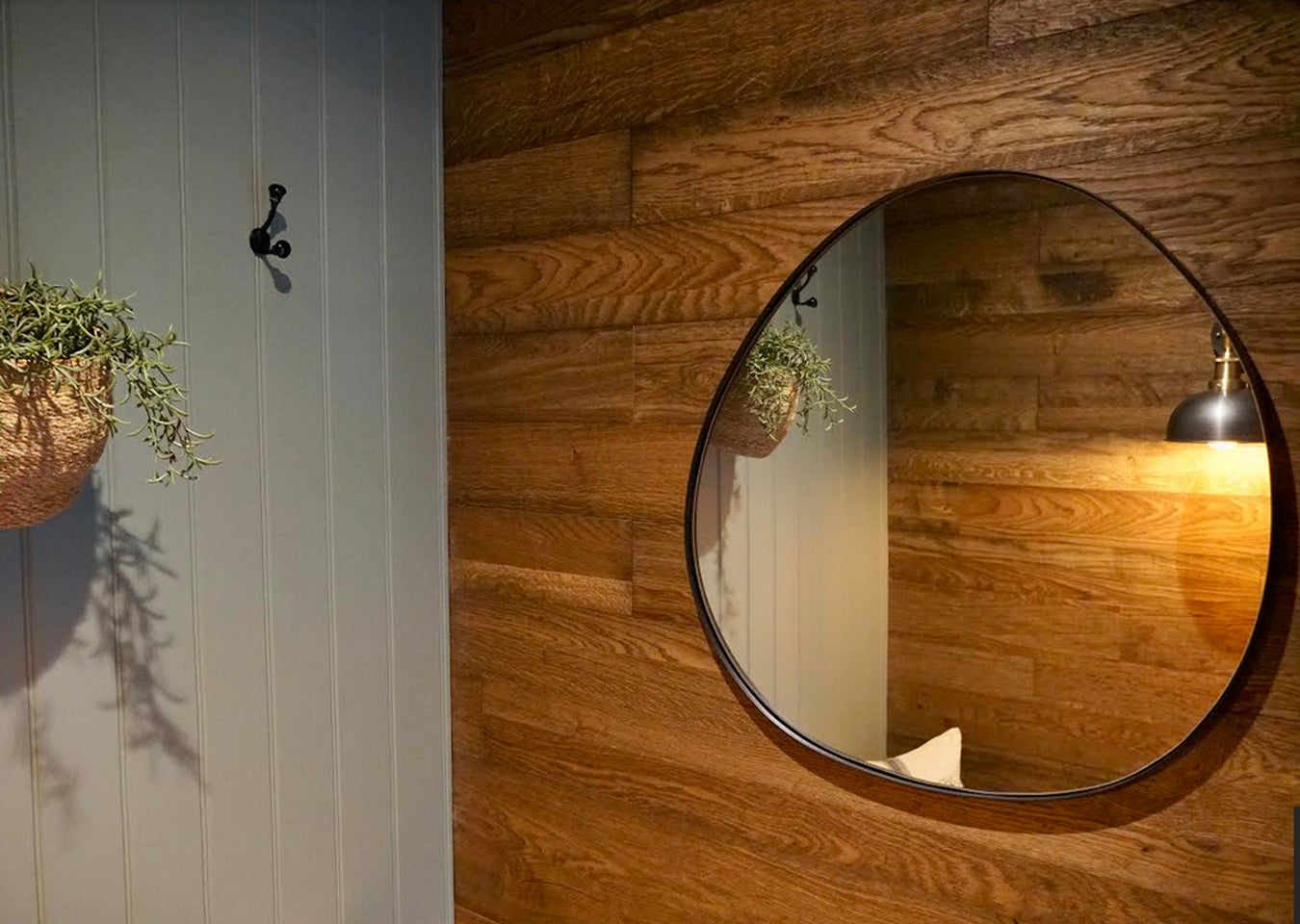 Peel & Stick Planks on wall behind a oval shaped mirror