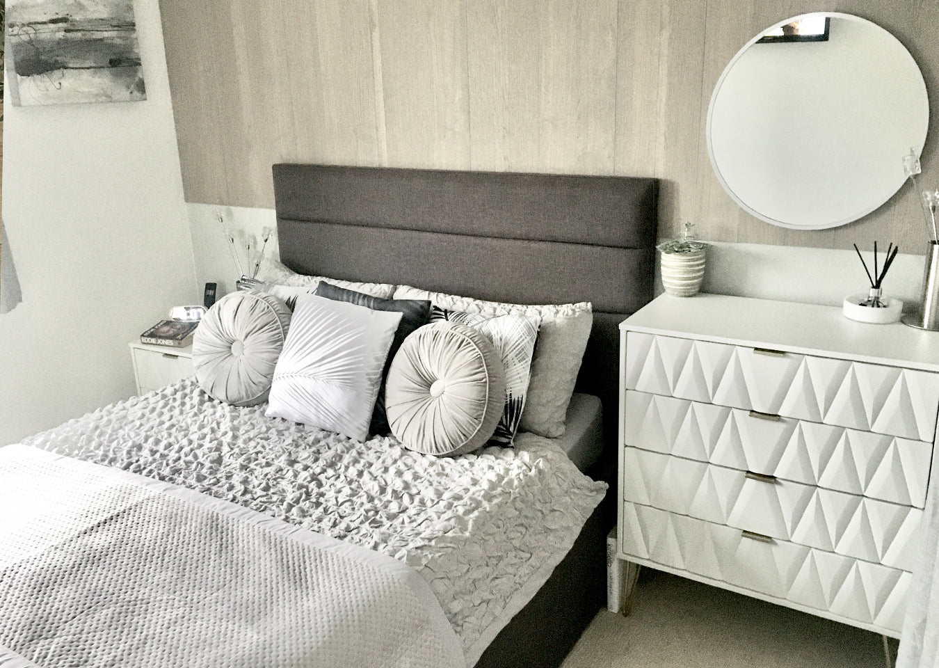 Grey and white themed bedroom. Bed with grey headboard. Wall behind has Sky Grey Peel & Stick planks on top half of the wall.