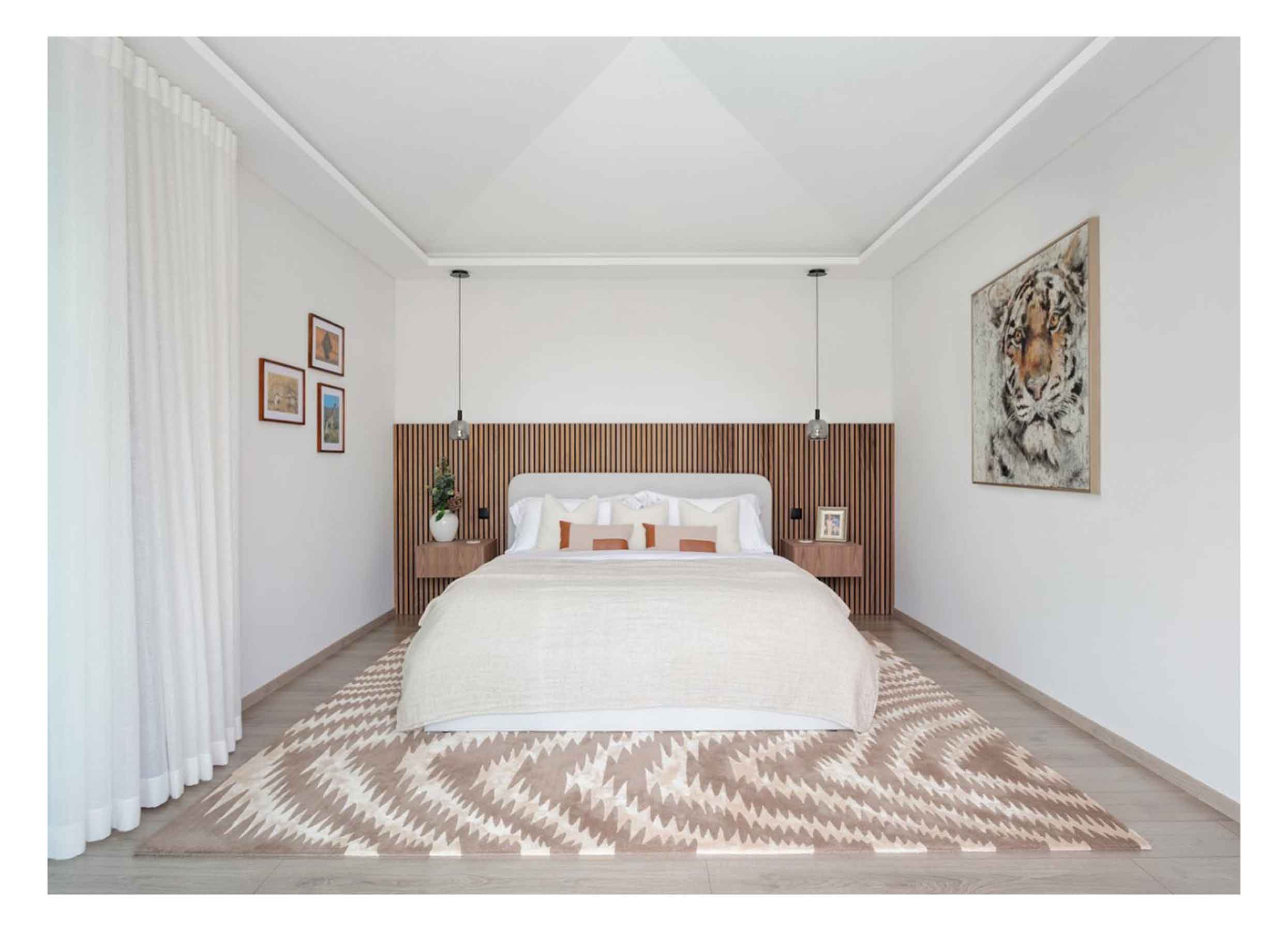 White bedroom featuring half-height oak wood panels for a headboard, coordinating side tables, a white bed and patterned rug.