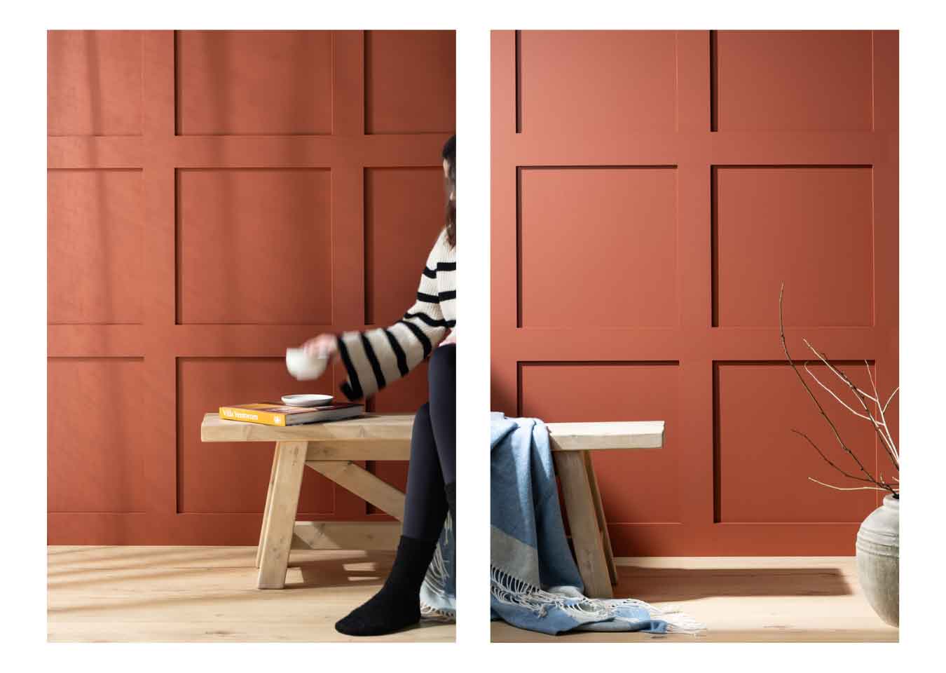 Woman wearing a striped jumper and black leggings holding a white cup sat on a bench in front of terracotta square shaker wall panels.