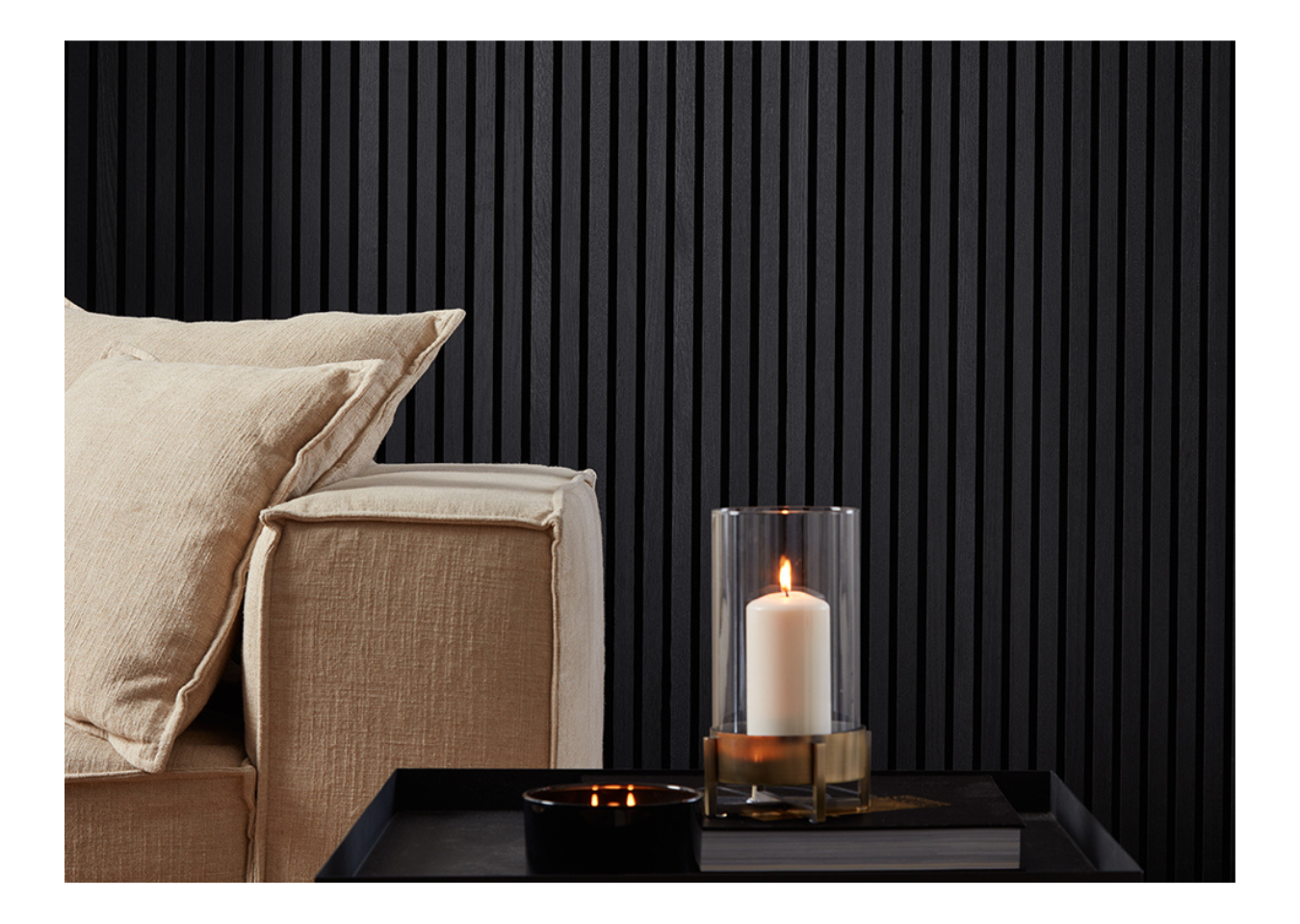 SlatWall Charcoal Black wall panelling behind a beige sofa and black table with a lantern candle.