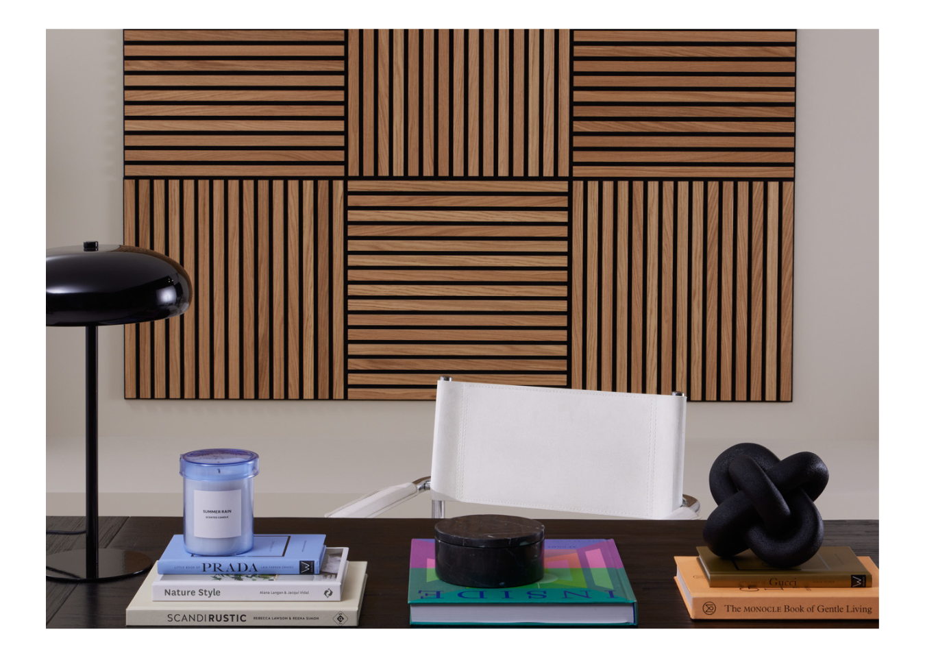3D wall art made from SlatWall Mini Oiled Oak panels behind a white chair and black desk with multicoloured accessories.