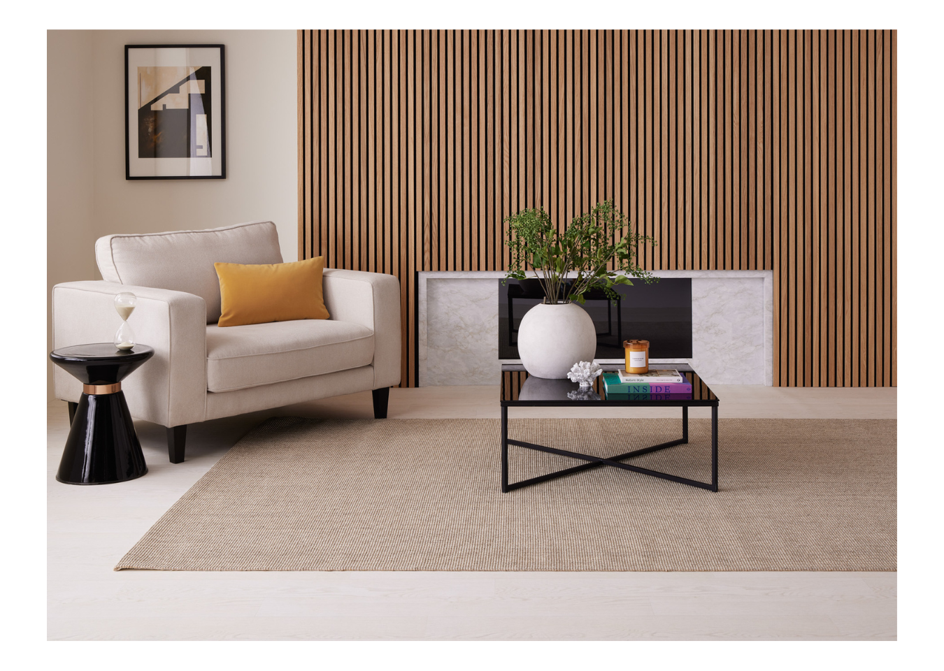 Summer home idea of a living room featuring SlatWall Oiled Natural Oak, a cream armchair, black tables and multicoloured décor.