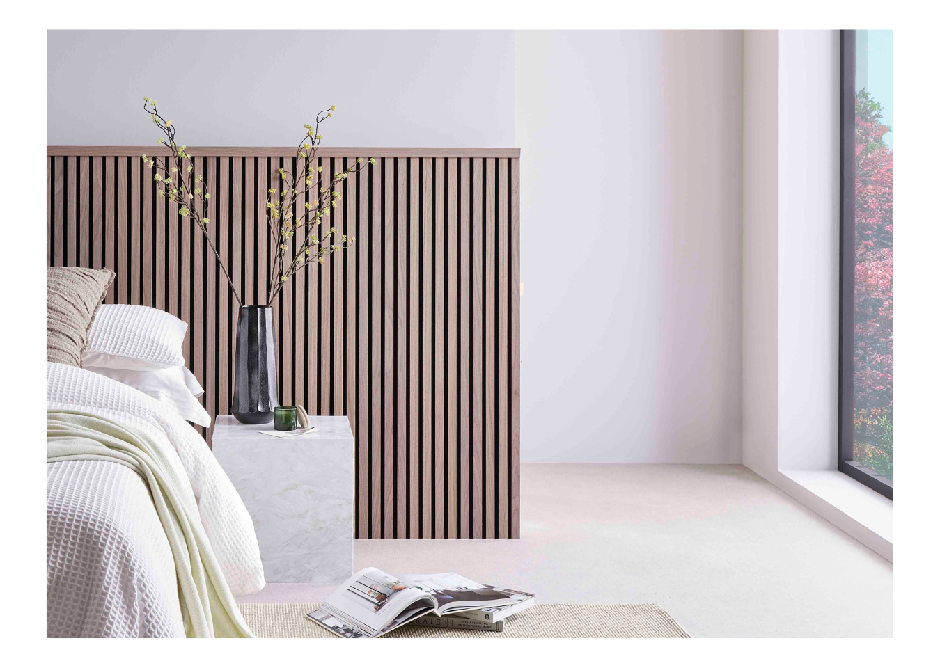 Biophilic design bedroom featuring SlatWall Midi Walnut panelling and Top Trim behind a white bed and marble bedside table.