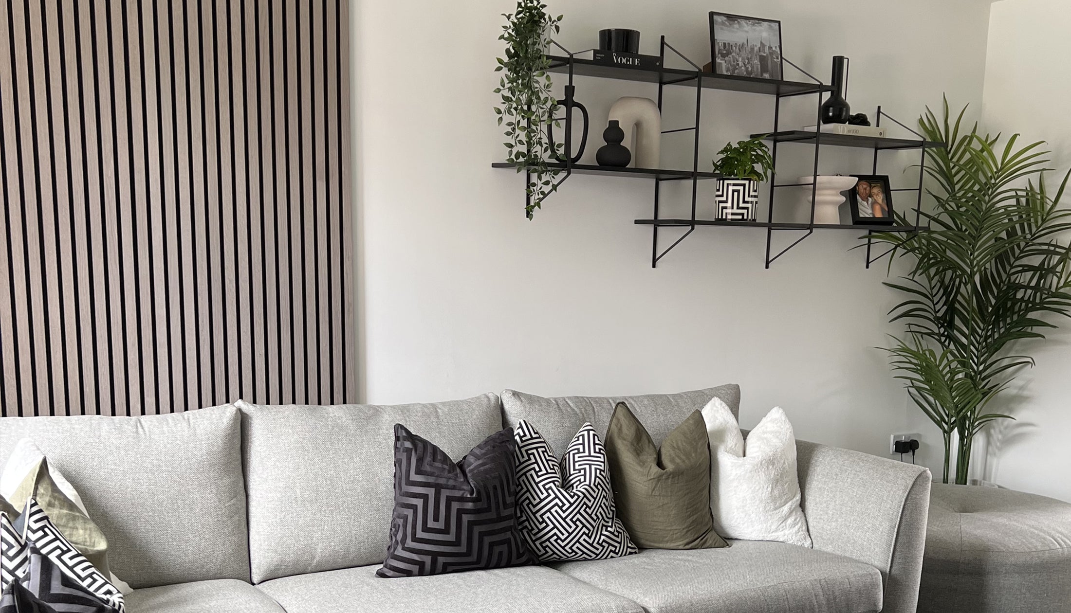 Grey sofa with Grey Oak slats on the wall.