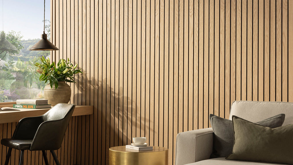 SlatWall Grand Natural Oak panels in a contemporary living space with green chair, vase of lilies, books and a pendant light.