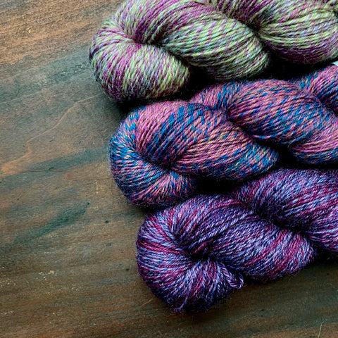 skeins of purple wool yarn by Queensland Collection
