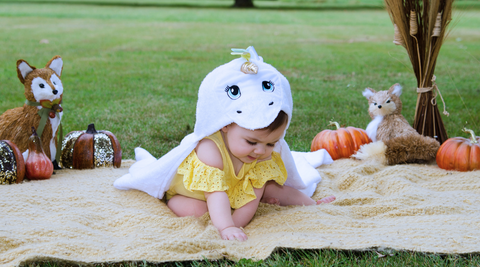 a girl child wearing kloud bambu white unicorn bamboo hooded towel for fall season