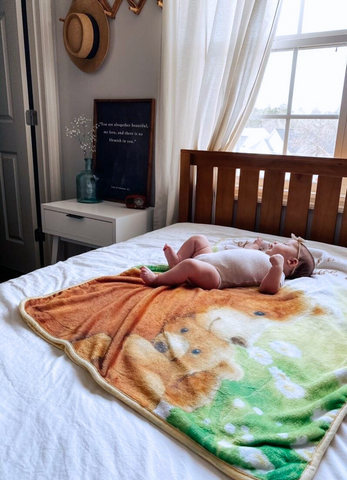 baby lying on bed with kloud bambu bamboo minky bear blanket