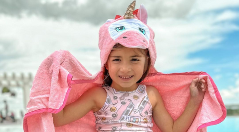 a girl child flaunting her kloud bambu pink unicorn bamboo hooded bath towel