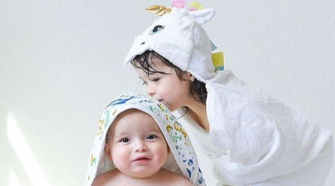 siblings wearing their favorite kloud bambu bamboo hooded bath towels