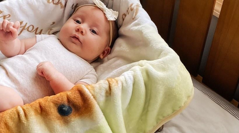 baby girl lying on her cradle with her kloud bambu minky blanket