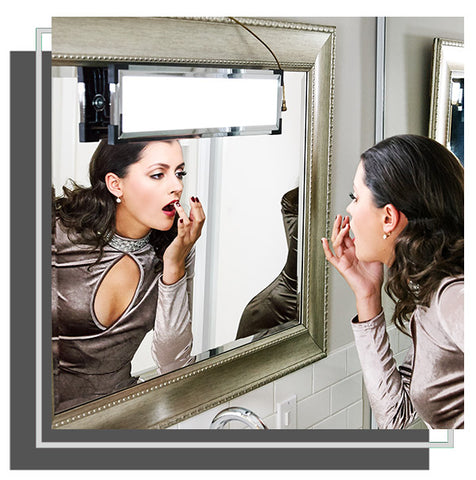 Woman adjusting her lipstick in mirror with Eyelight