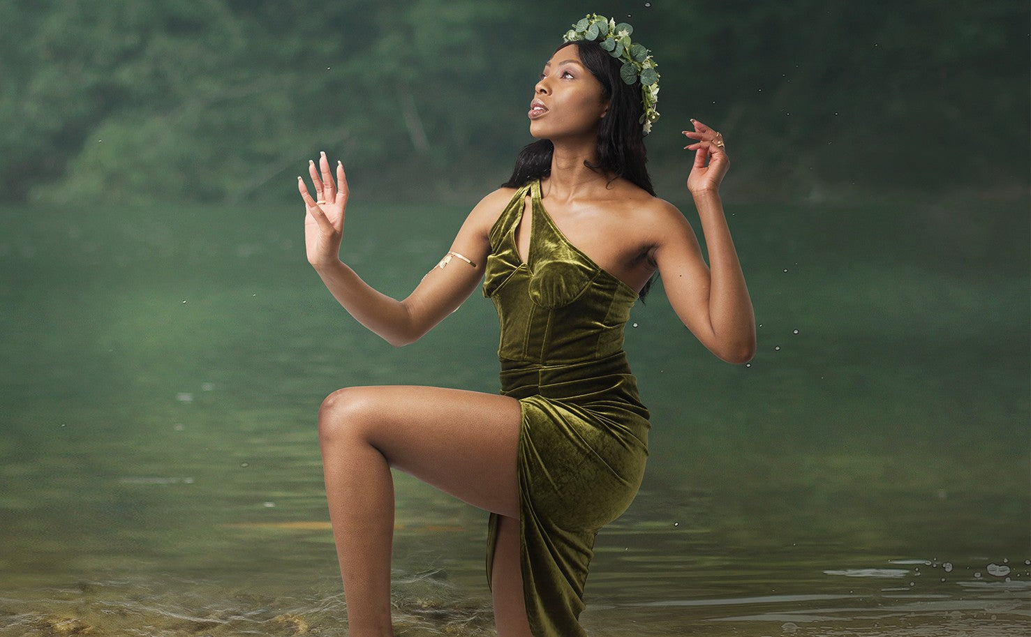 Naturally Wicked Earth Queen In Green Earthy Dress Kneeling In Water & Looking Up To Sky