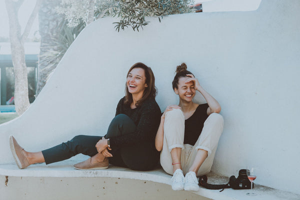 Two girls laughing in the sun