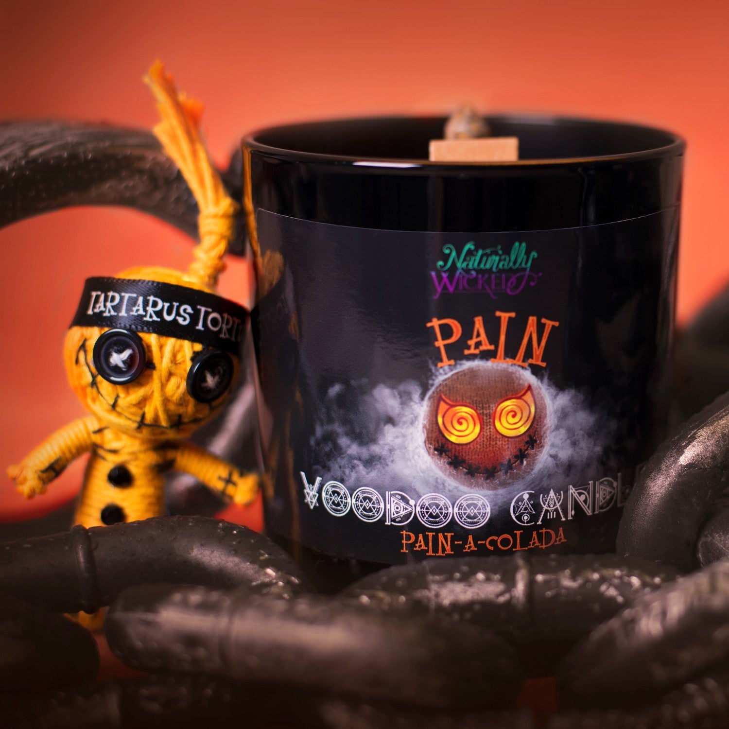 Naturally Wicked Voodoo Pain Spell Candle Amongst Torture Chains & Orange Voodoo Pain Doll