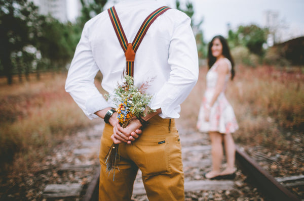 Gentleman giving lady surprise flowers