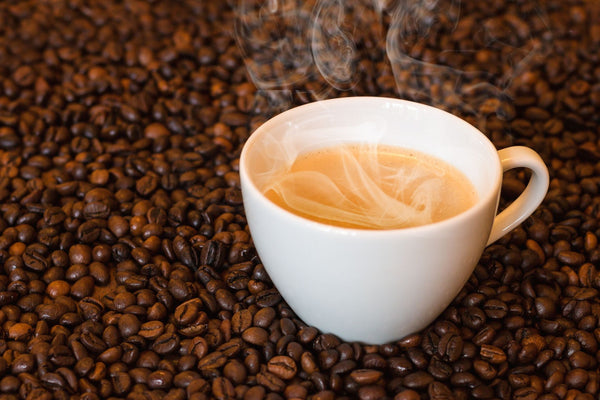 Flat White Coffee Surrounded By Coffee Beans