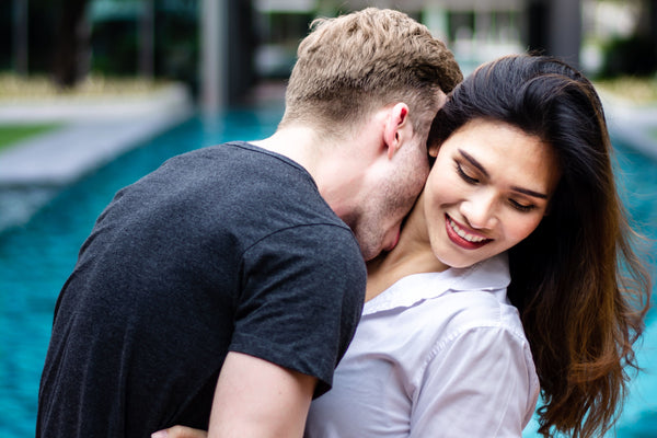 Man kissing Woman's Neck