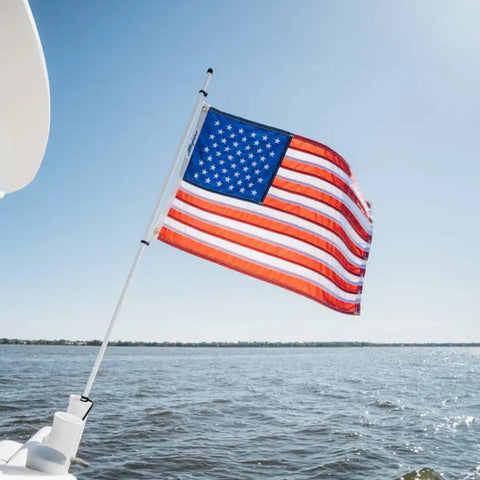 A U.S. flag flutters on a boat-mounted pole, demonstrating flagpole durability in marine environments.