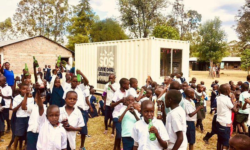 School children in Kenya making use of a library made from an old shipping container