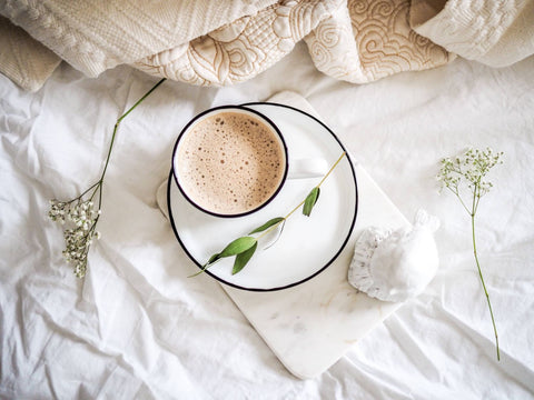 coffee on bed with flowers