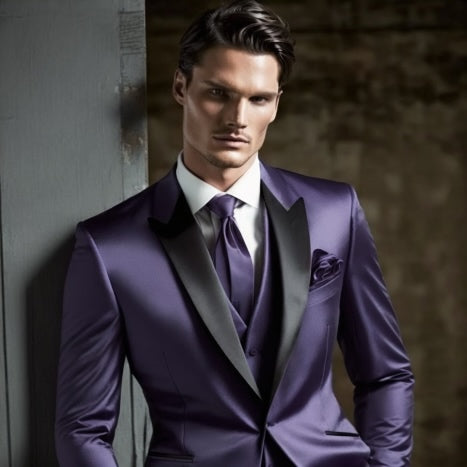 Sophisticated male model in a sharp, satin-finished purple suit with a peak lapel, matching tie and pocket square, exuding luxury and style.