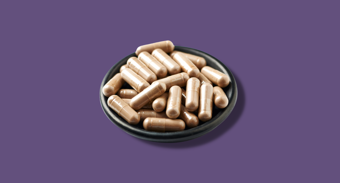 Reishi Mushroom Capsules with purple background. The Wee Hemp Company Reishi Supplement 12,000mg active fungi compounds.