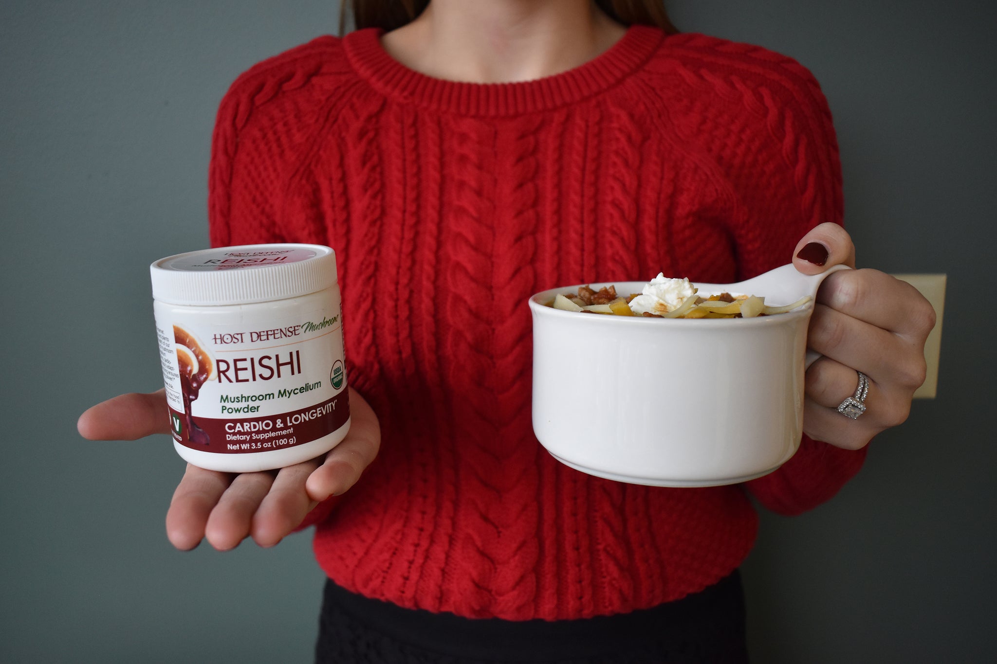 Woman holding Reishi Powder and cup of chili