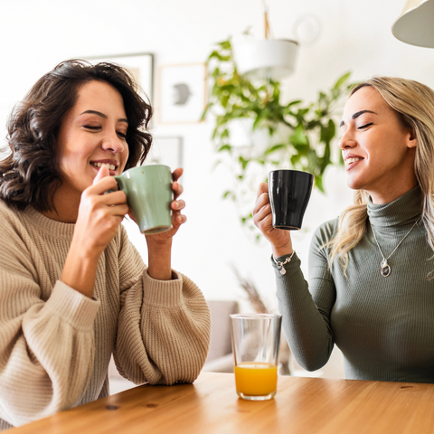 two women drinkign coffee