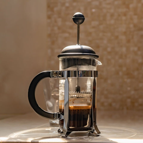 french press making coffee