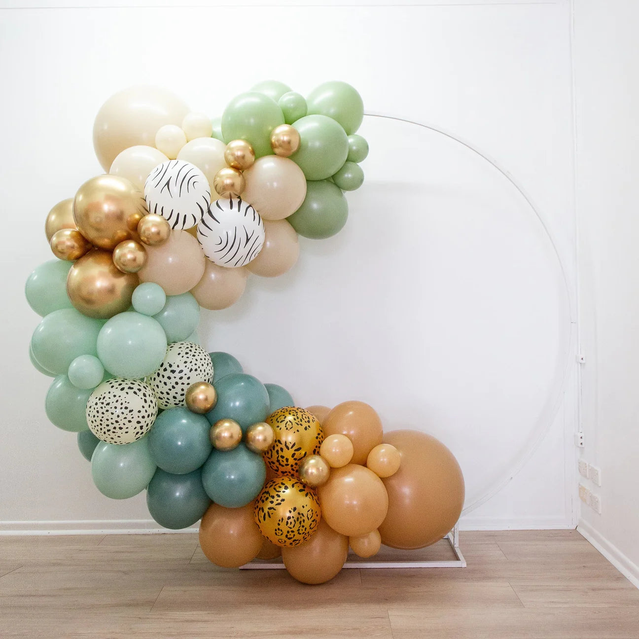 Into the wild balloon garland kit. Balloons in shades of green for safari style celebration.