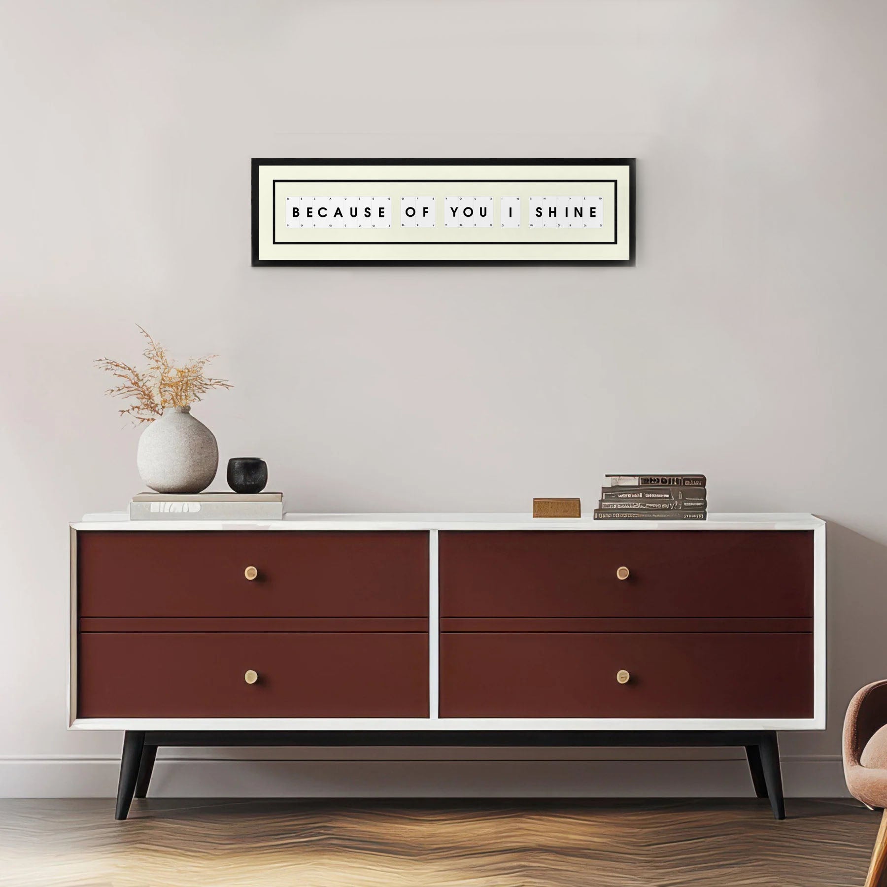 an example of a Personalised Playing Card Picture Frame displayed on a grey wall with an elegant modern chest of drawers underneath.