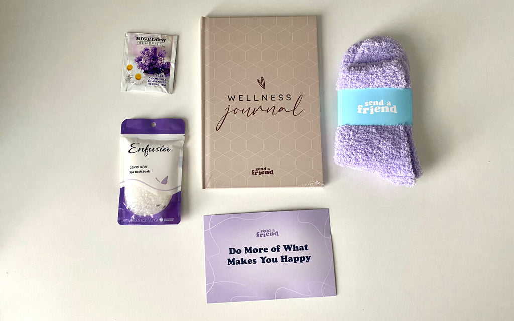 Lavender tea, bath soak, fuzzy socks, wellness journal, and a promo card