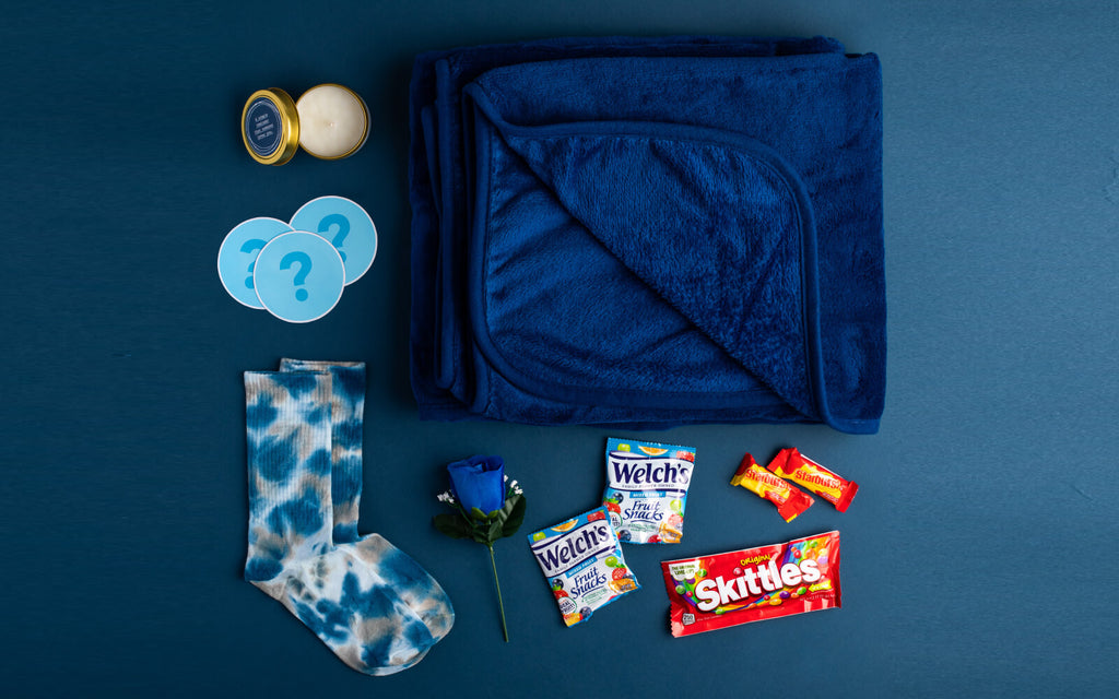 Candle, socks, blanket, candy, and blue rose