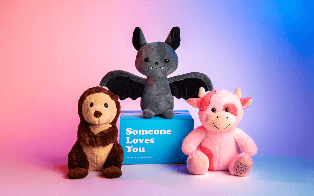 Image of Oliver the Otter, Binks the Bat sitting on a Someone Loves You box, and Sally the Strawberry Cow