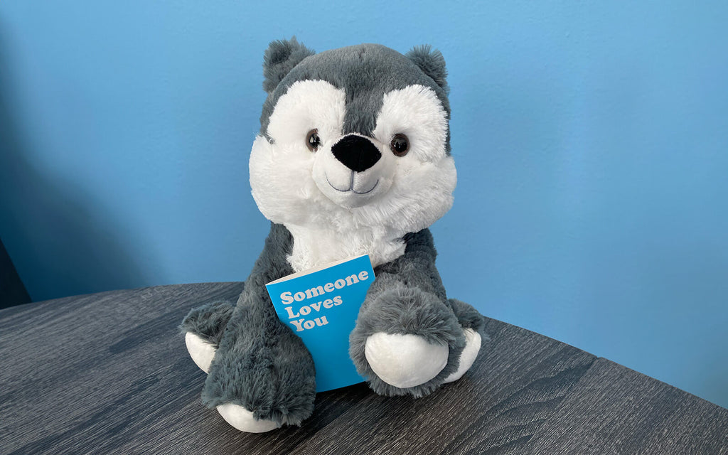 An image of Winston the Wolf holding the "Someone Loves You" notecard