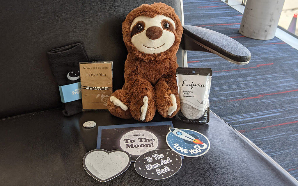 Pictured is Sam the Sloth with SendAFriend's "To The Moon & Back" bundle