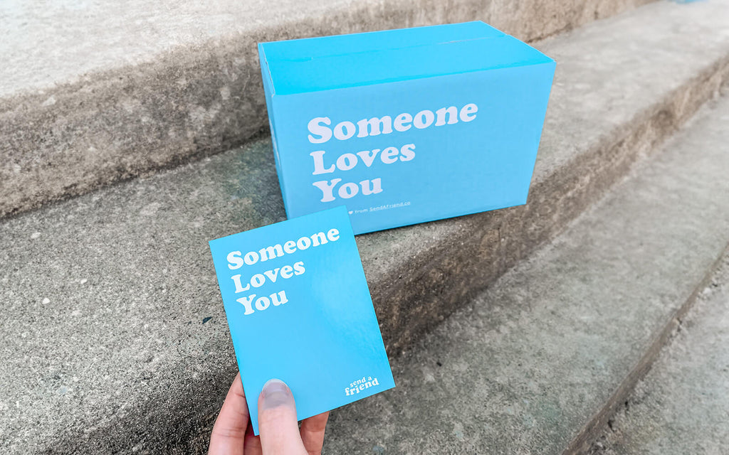 An image of the signature blue "Someone Loves You" box and notecard