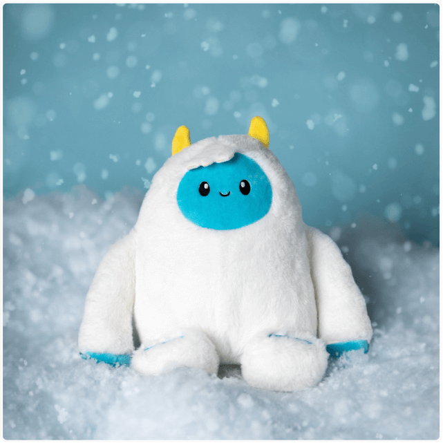 Cute Yuka the Yeti stuffed plushie sitting on a pile of snow
