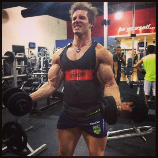 Aaron Curtis training with the red Strong Lift Wear Arm Blaster!