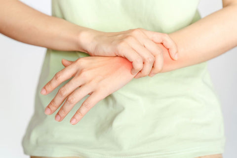 A woman touches her wrist because of an arthritis